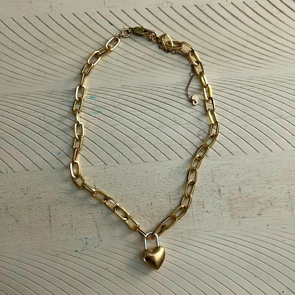 Golden heart lock necklace on a thick chain